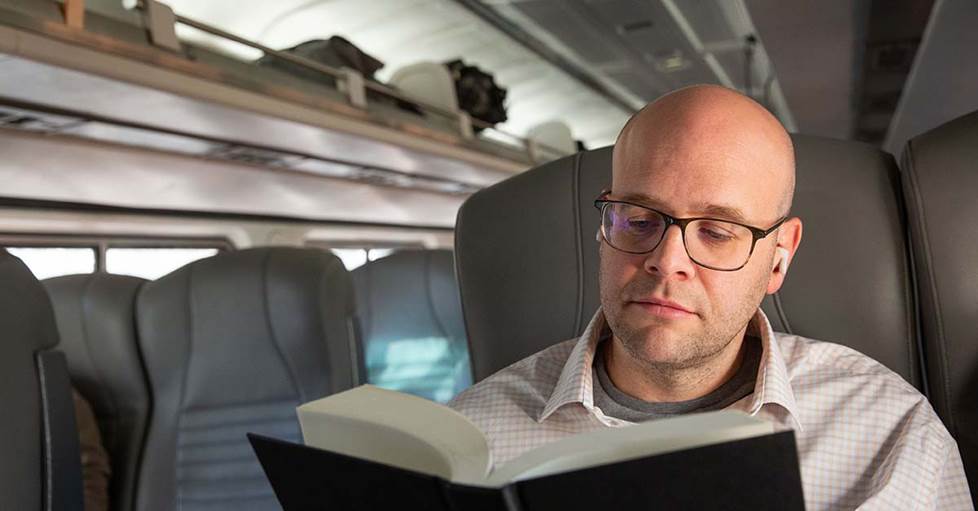 Jeff on train with Bose QC earbuds